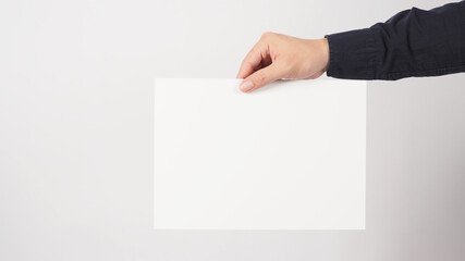 blank empty paper in man hand and wear navy blue shirt on white background.asian people