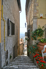 Fototapeta na wymiar An alley in the medieval quarter of Maenza, a medieval town in the Lazio region. Italy.