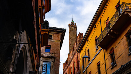 Fototapeta na wymiar Torre della Garisenda in Bologna seen between historic buildings. Italy