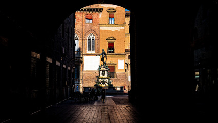view of the fountain of Neptune from the Portici. Bologna, Italy.