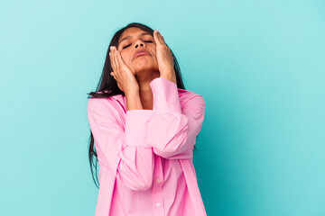 Young latin woman isolated on blue background whining and crying disconsolately.