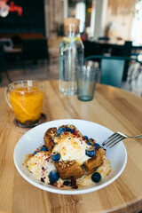 plate with ice cream and cake on the table in cafe