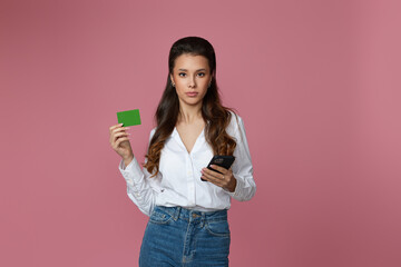 woman holding bag, credit bank card and mobile phone