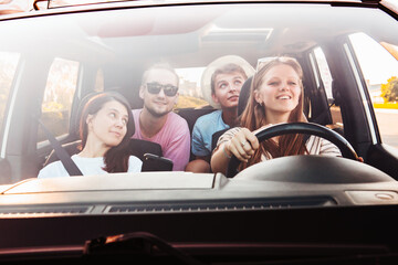 four friends in car navigation on phone