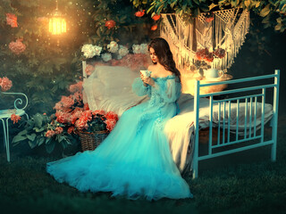 Fairy tale princess sits on white bed. Fantasy woman holding cup in hands drinking tea. Long wave...