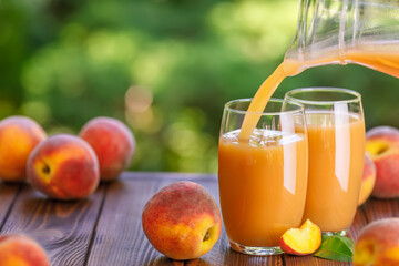 fresh peach juice pouring into glass outdoors