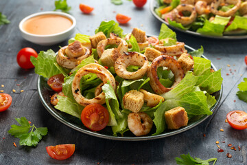 Grilled squid or calamari and prawns salad with garlic croutons and cherry tomatoes