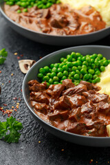 Slow Cooked Steak Diane Casserole with mushroom. mashed potatoes and green peas