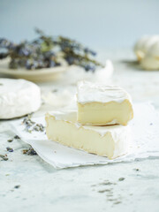 Camembert cheese on a background of garlic and lavender