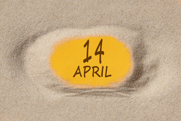 April 14. 14th day of the month, calendar date. Hole in sand. Yellow background is visible through hole. Spring month, day of the year concept