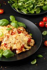 Baked Cauliflower steak with marinara sauce and cheese on plate. Healthy vegetarian food