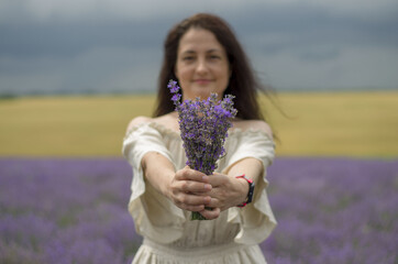 Naklejka na ściany i meble lavender field with sky and clouds and beutyful model