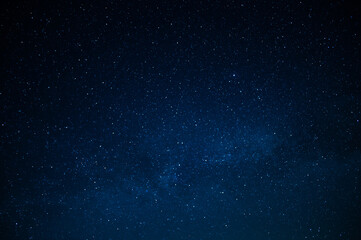 Night starry sky. Milky Way. Many stars twinkle in the dark blue sky. Minimalism. There are no people in the photo. Background. Texture. Wallpaper. - 447144676