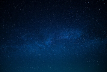 Milky Way. Night starry sky. Various shades of blue. Small stars twinkle in the sky. There is no...