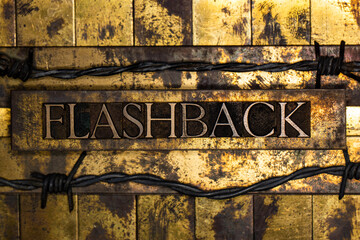 Flashback text between barbed wire on vintage textured grunge lead copper and gold bar background