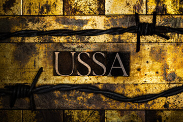 USSA text between barbed wire on vintage textured grunge gold and copper background