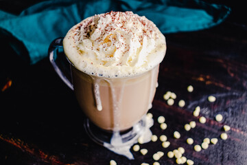 White Chocolate Latte Topped with Whipped Cream and Cocoa Powder: A sweet coffee drink made with white chocolate and whipped cream