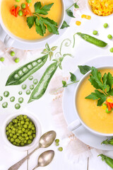 Pea soup with vegetables on a white wooden background
