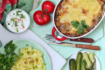 Chicken julienne with mashed potatoes on a green background