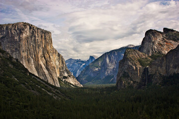 Depth of Yosemite valley with beautiful high peaks and waterfall