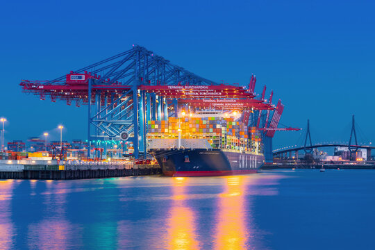 Hamburg, Germany - March 24, 2017: The container ship CMA CGM Benjamin Franklin is unloaded at the terminal Burchardkai (CTB) in the harbor at dusk.