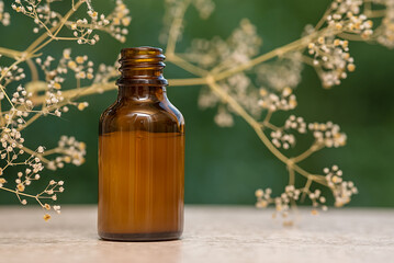 Cosmetic oil. Herbal essence. Alternative health medicine. Skin care. Summer on the background of boke.