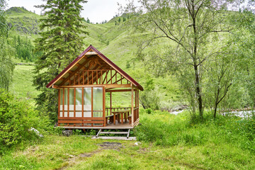 Holistay house. Countryside hiking. Vacation landscape. Russian Altai mountains. Staycation concept. Reduce carbon footprint. Sustainable lifestyle. Holiday trail. Local travel