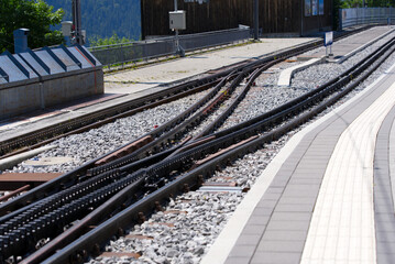 Close-up of cog railway track switch at train station of Wengen on a beautiful summer day. Photo taken July 20th, 2021, Lauterbrunnen, Switzerland.