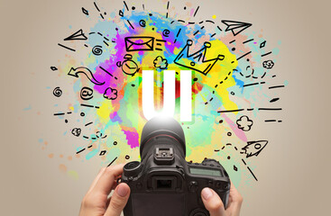 Close-up of a hand holding digital camera with abstract drawing