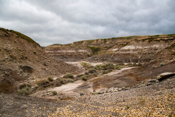 A stark view of the Alberta badlands just outside the Royall Tyrrell Museum of Paleontology in Drumheller, Alberta on a dark and gloomy day.