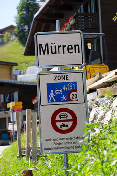 Road signs at mountain village Mürren in the Swiss alps on a sunny summer day. Photo taken July 20th, 2021, Lauterbrunnen, Switzerland.