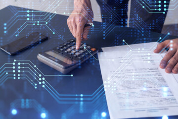 A research and development specialist computing the data to create a new approach to develop high tech business. Technological icons over the desk with calculator.