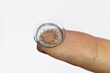 colored soft contact eye lenses close up on finder