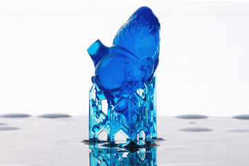 Mini blue heart printed on high-precision 3d printer on white background