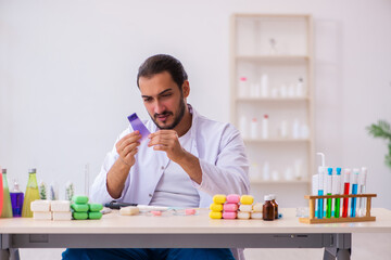 Young male chemist testing soap in the lab