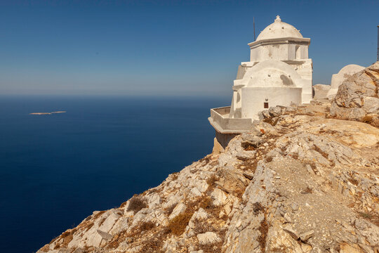 Kalamiotissa monastery on the high rocky mountain on Greek island Anafi in Cyclades, Greece