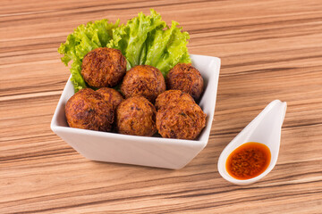 portion of dried meat dumpling on wooden background