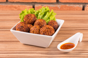 portion of dried meat dumpling on wooden background