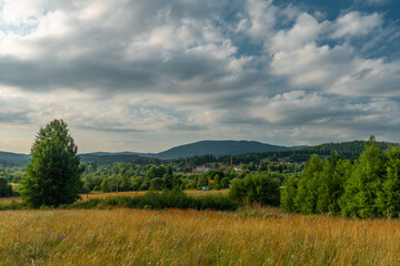 Lookout place with bench and old house near Lenora village in summer evening