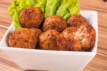 portion of dried meat dumpling on wooden background