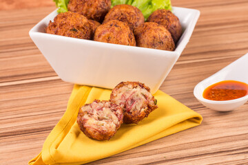 portion of dried meat dumpling on wooden background