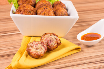 portion of dried meat dumpling on wooden background