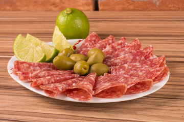 portion of salami on wooden background