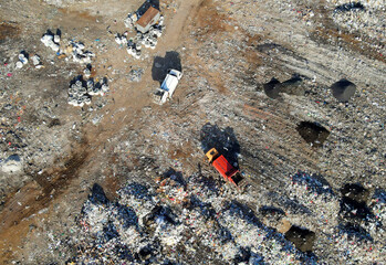 Garbage dump with food waste. Arial view of garbage truck unloads rubbish in landfill. Plastic rubbish dump. Reduce greenhouse gas emissions and methane emissions. Environmental protection