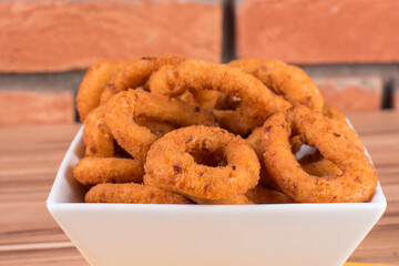 portion of onion rings on wooden background