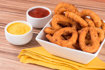 portion of onion rings on wooden background
