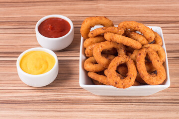 portion of onion rings on wooden background