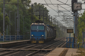 Obraz premium Trains and whistle stop Olesko in central Bohemia in sunset orange evening
