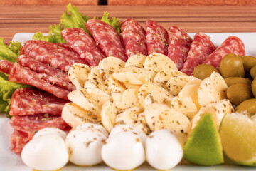 portion of cheese and salami on wooden background