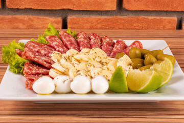 portion of cheese and salami on wooden background